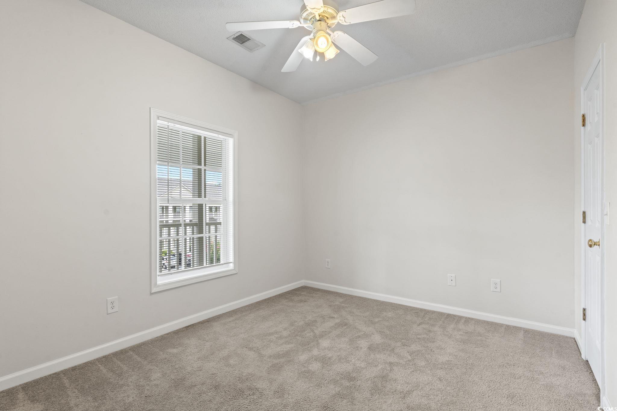 5810 Longwood Drive, Unit 14304 Murrells Inlet, SC 29576 - Photo 6 of 30 Carpeted empty room with baseboards and ceiling fa
