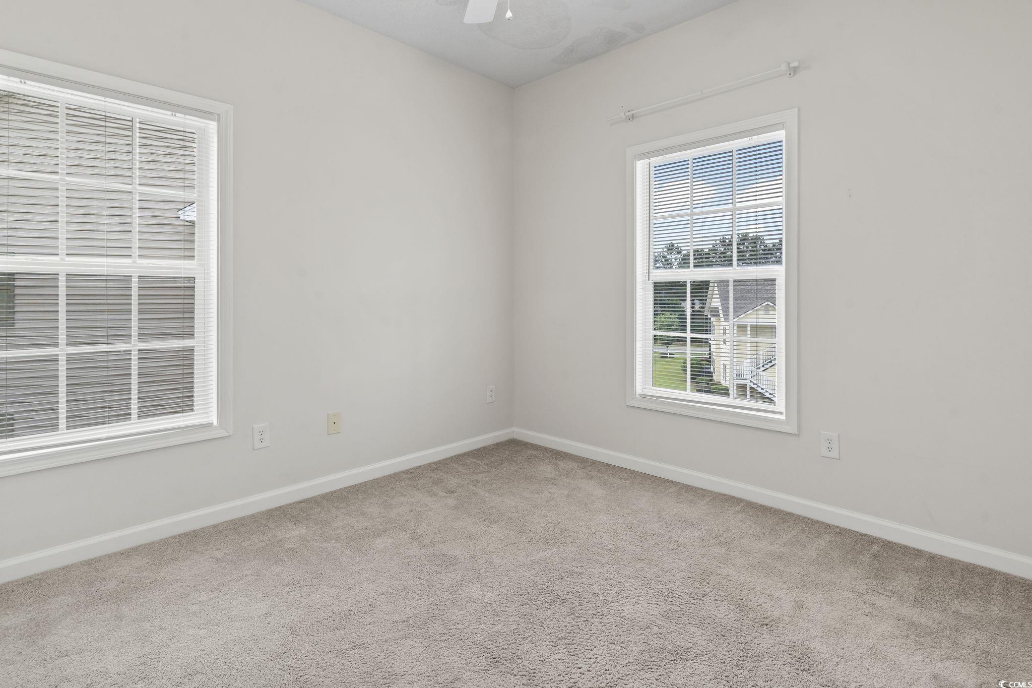 5810 Longwood Drive, Unit 14304 Murrells Inlet, SC 29576 - Photo 7 of 30 Empty room with carpet and ceiling fan