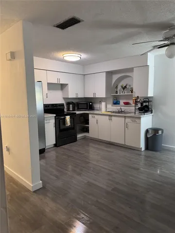 a kitchen with stainless steel appliances granite countertop a stove and a refrigerator