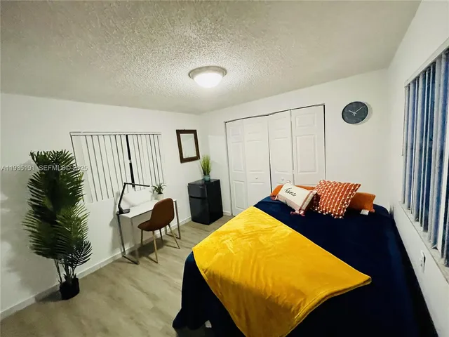 a bed room with a bed and a chair