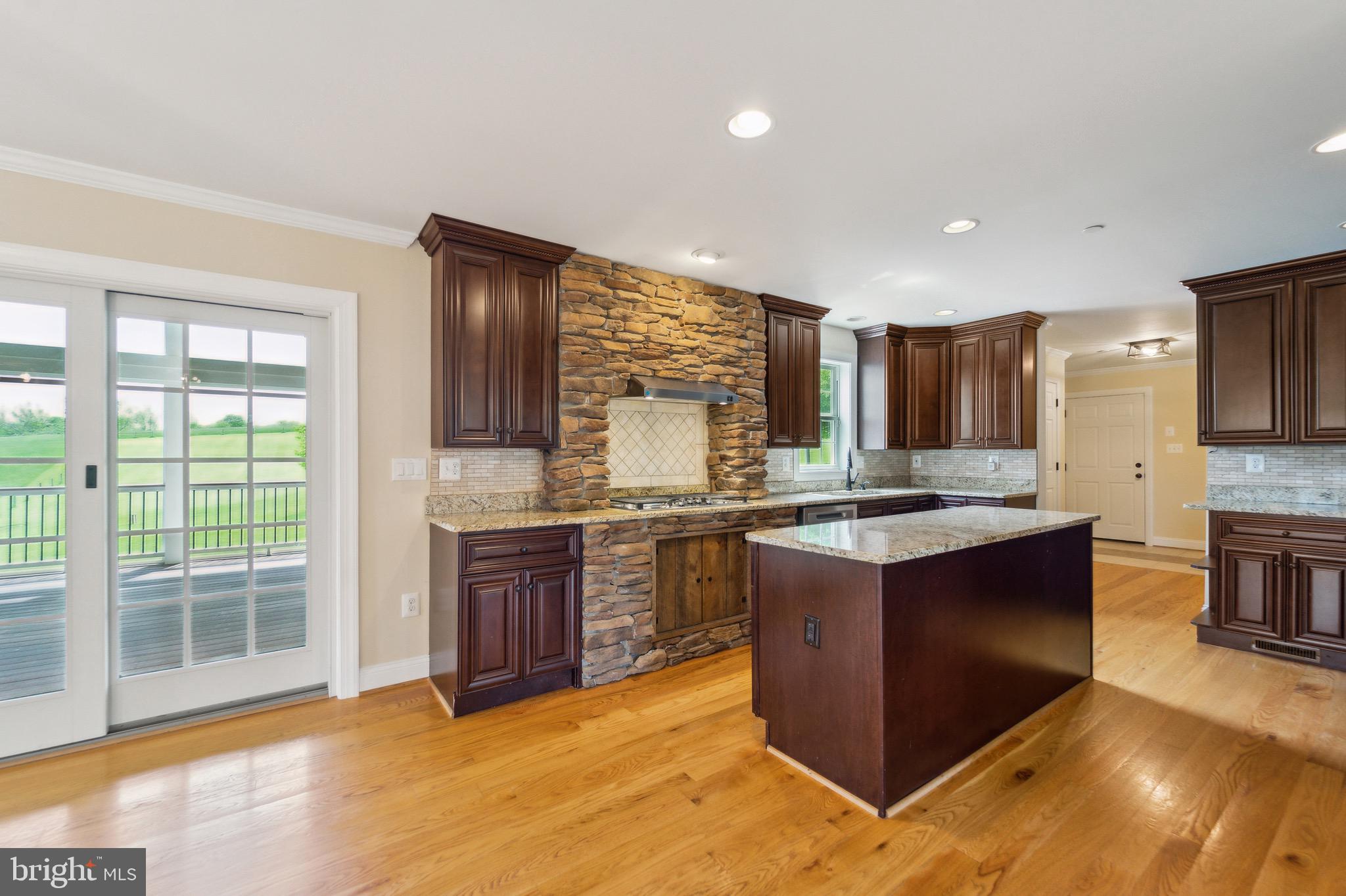4905 Bartholows Road Mount Airy, MD 21771 - Photo 11 of 70 a large kitchen with stainless steel appliances granite countertop a stove and cabinets