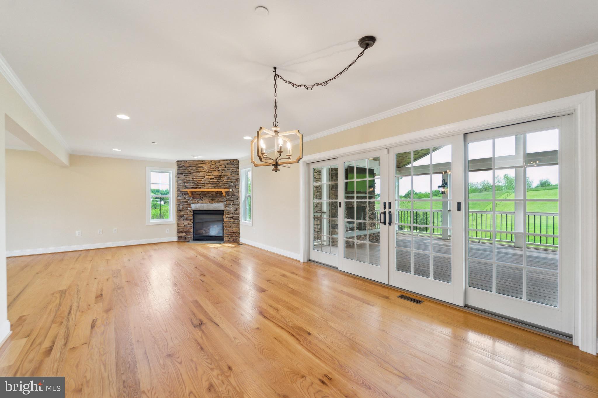 4905 Bartholows Road Mount Airy, MD 21771 - Photo 12 of 70 a view of empty room with wooden floor and fireplace
