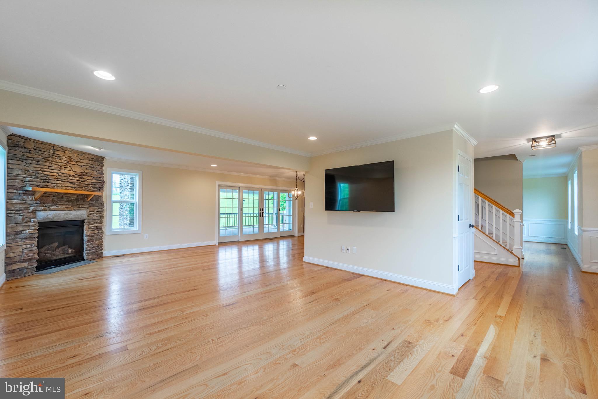 4905 Bartholows Road Mount Airy, MD 21771 - Photo 15 of 70 a view of a livingroom with wooden floor and a fireplace