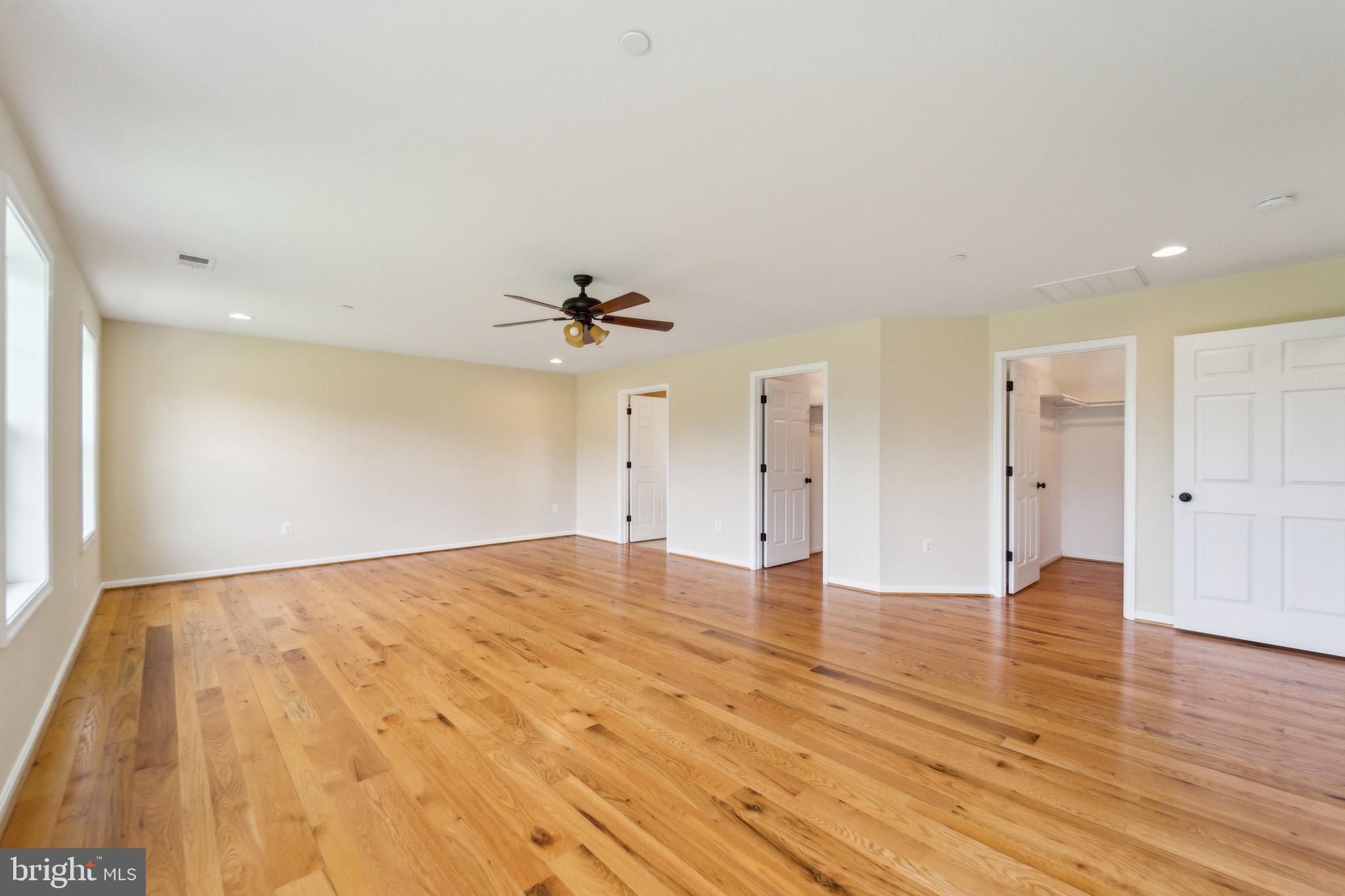 4905 Bartholows Road Mount Airy, MD 21771 - Photo 21 of 70 a view of an empty room with wooden floor and a ceiling fan
