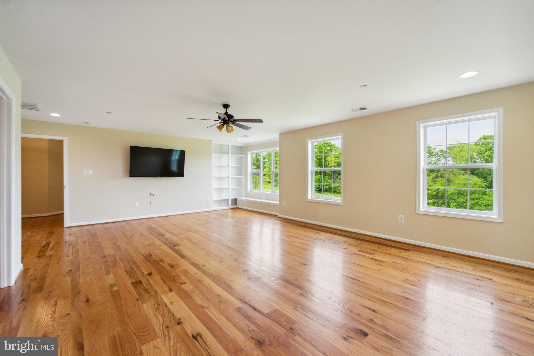 4905 Bartholows Road Mount Airy, MD 21771 - Photo 22 of 70 a view of an empty room with wooden floor and a window