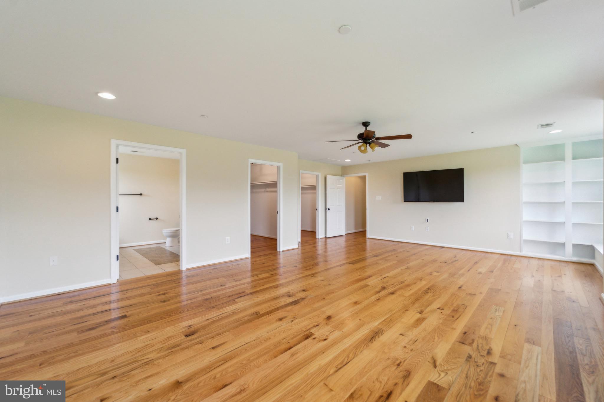 4905 Bartholows Road Mount Airy, MD 21771 - Photo 23 of 70 a view of a livingroom with wooden floor a ceiling fan and window