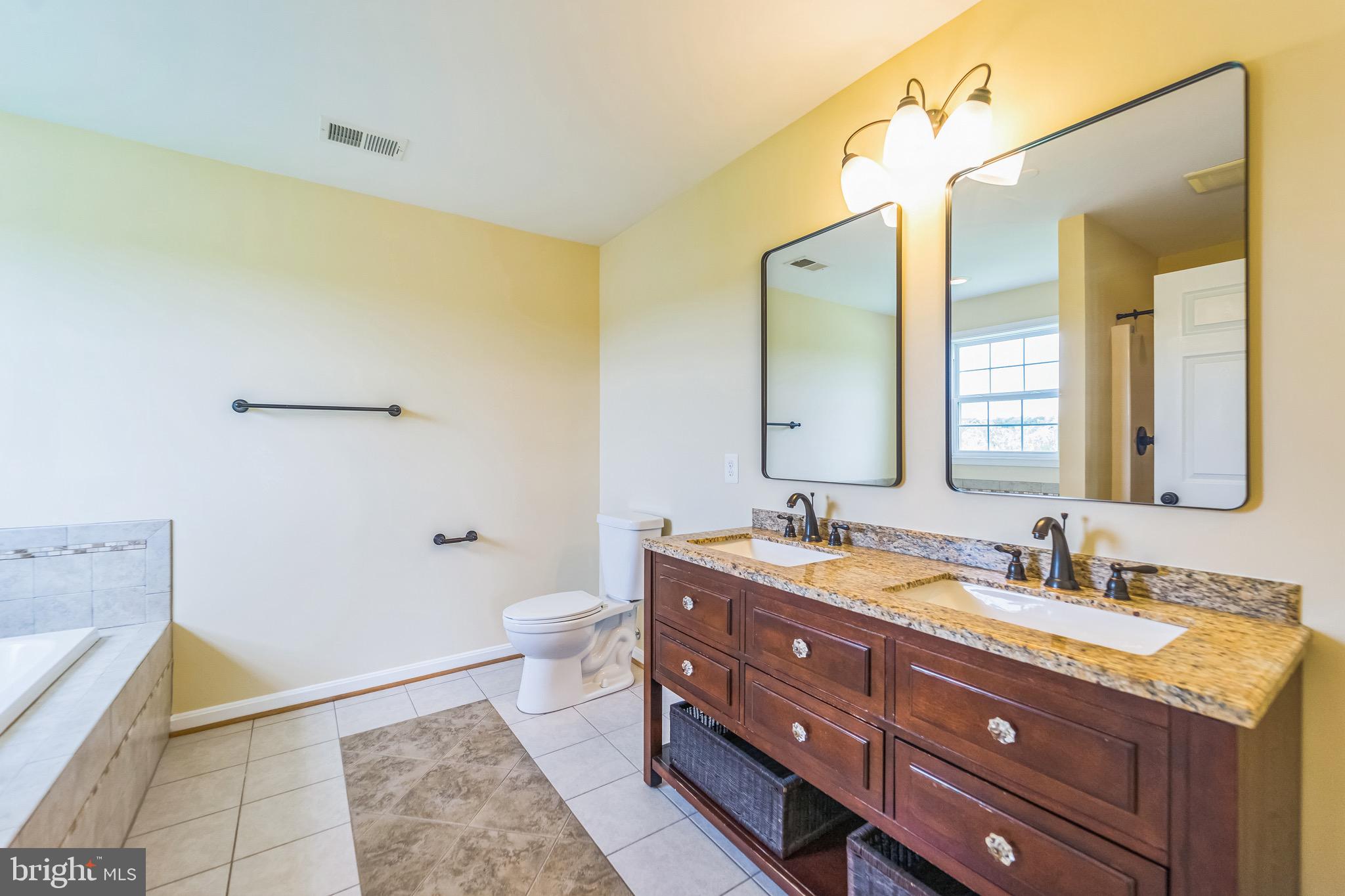 4905 Bartholows Road Mount Airy, MD 21771 - Photo 24 of 70 a bathroom with a granite countertop sink toilet and mirror