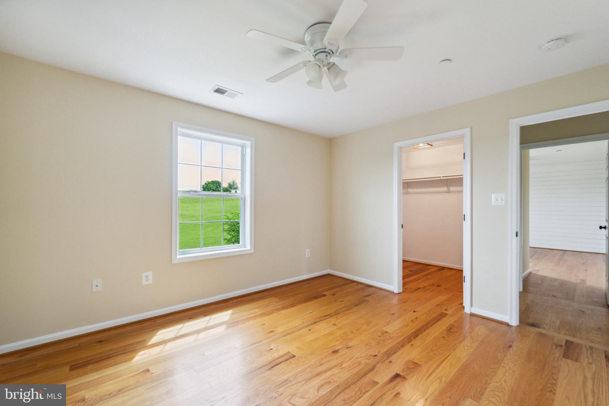 4905 Bartholows Road Mount Airy, MD 21771 - Photo 26 of 70 an empty room with wooden floor and windows