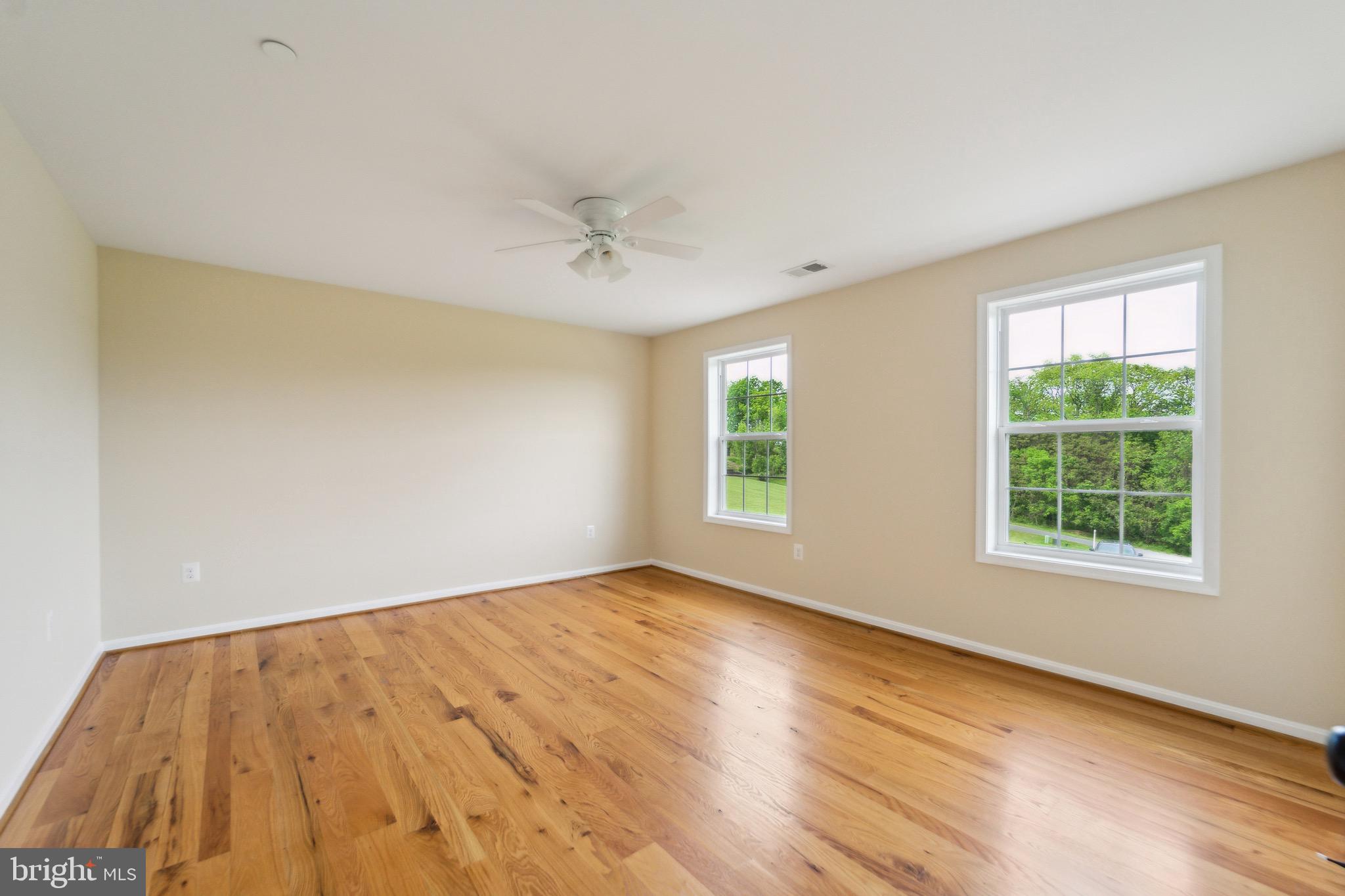 4905 Bartholows Road Mount Airy, MD 21771 - Photo 28 of 70 a view of an empty room with wooden floor and a window
