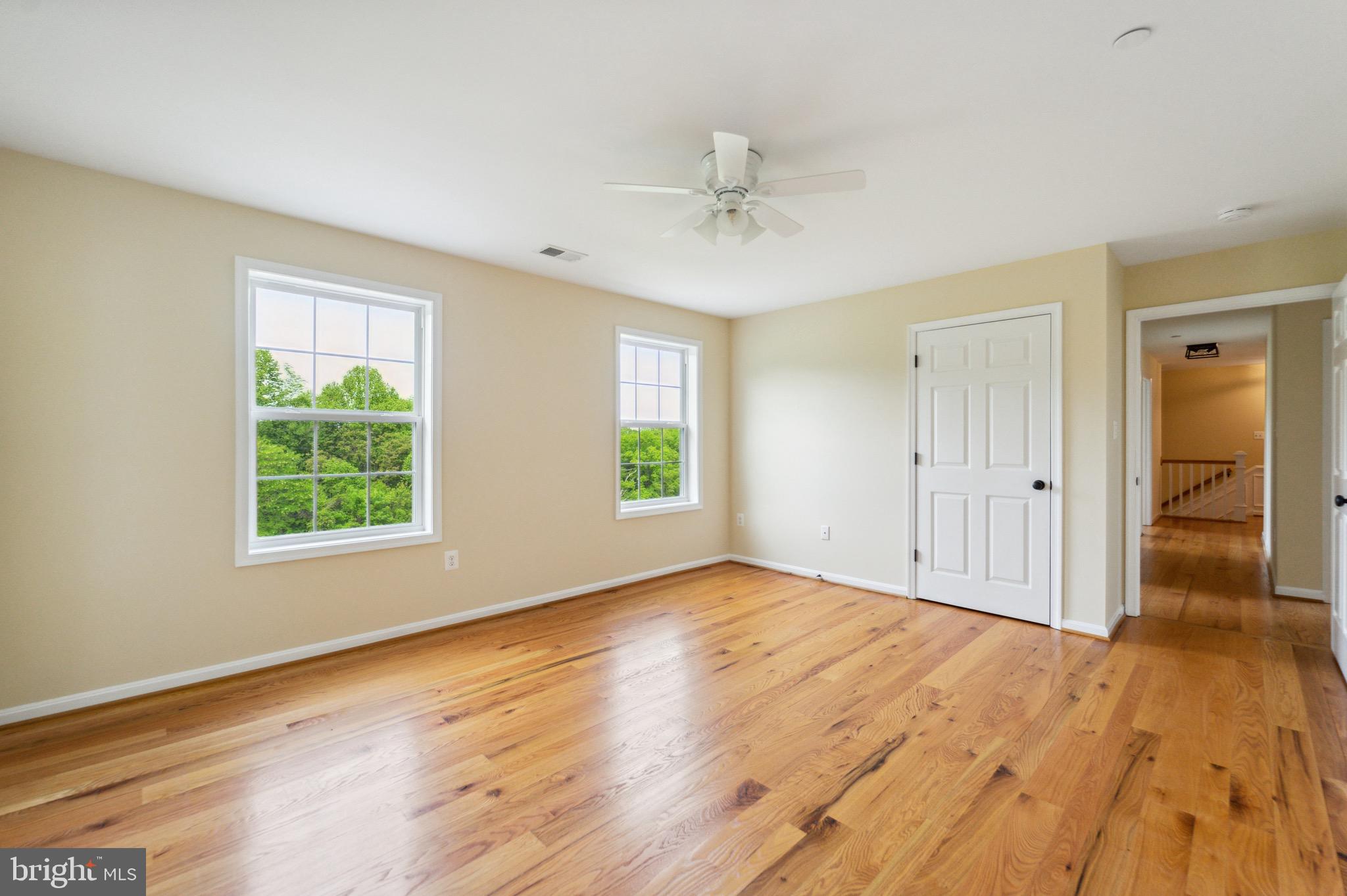 4905 Bartholows Road Mount Airy, MD 21771 - Photo 29 of 70 a view of an empty room with wooden floor and a window