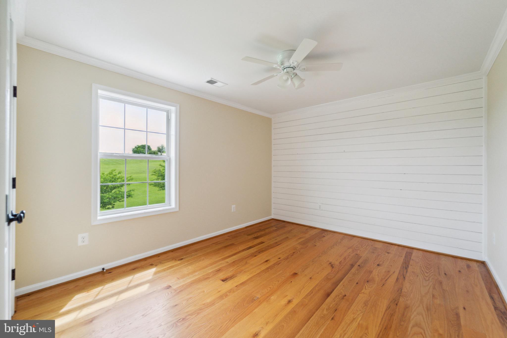 4905 Bartholows Road Mount Airy, MD 21771 - Photo 30 of 70 a view of an empty room with wooden floor and a window