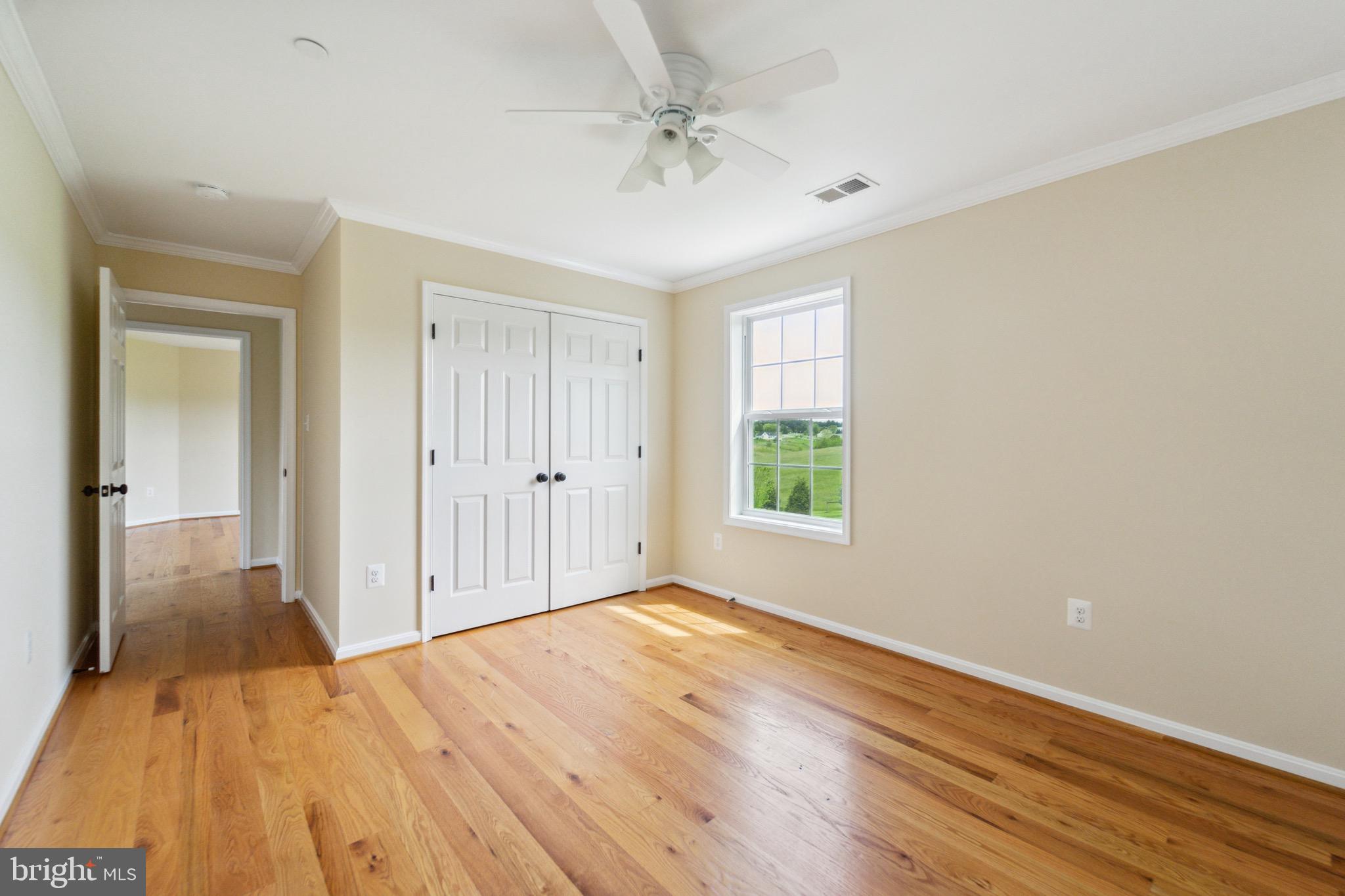 4905 Bartholows Road Mount Airy, MD 21771 - Photo 31 of 70 a view of a livingroom with wooden floor and a ceiling fan