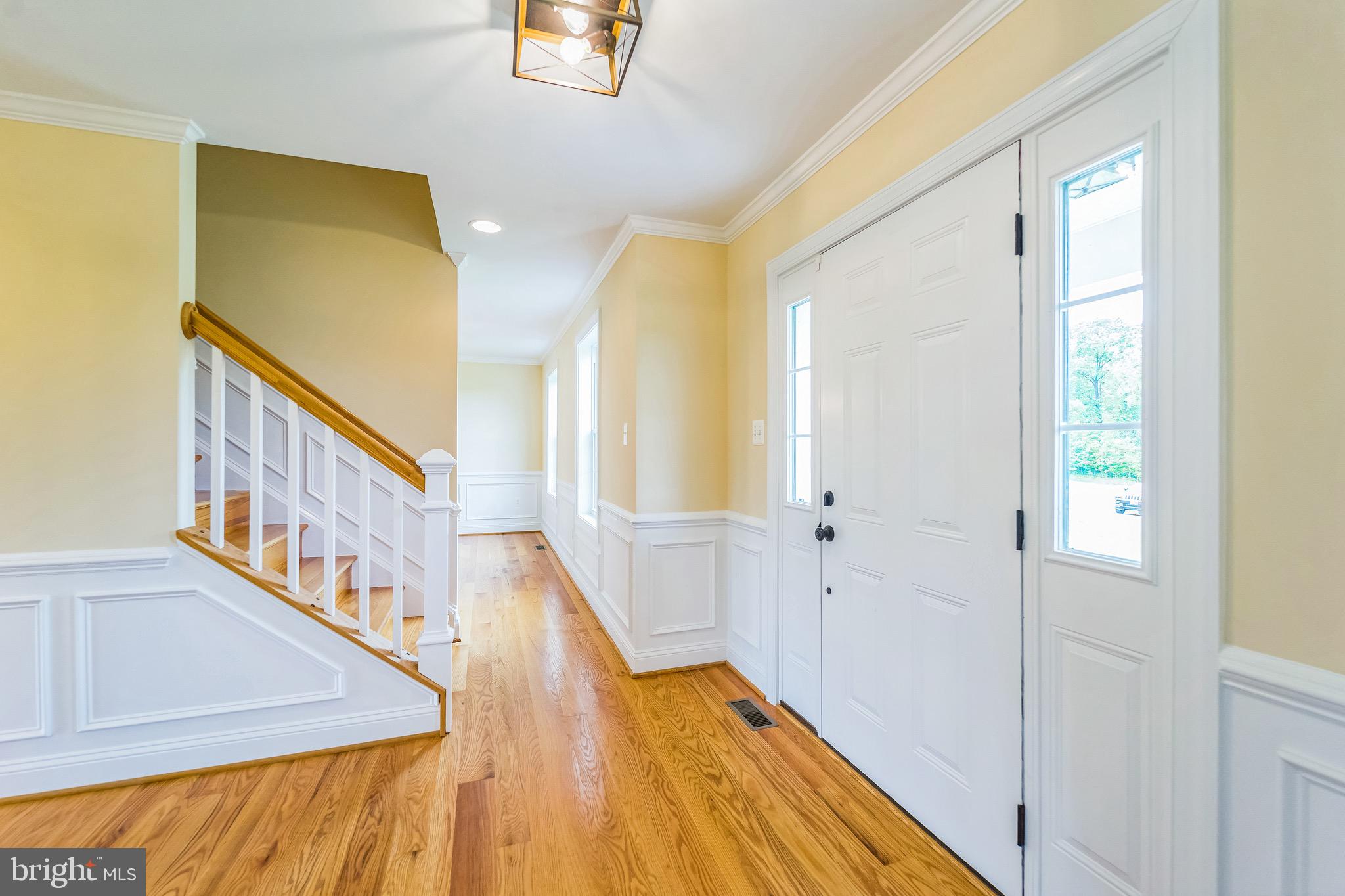 4905 Bartholows Road Mount Airy, MD 21771 - Photo 4 of 70 a view of a hallway with wooden floor and staircase