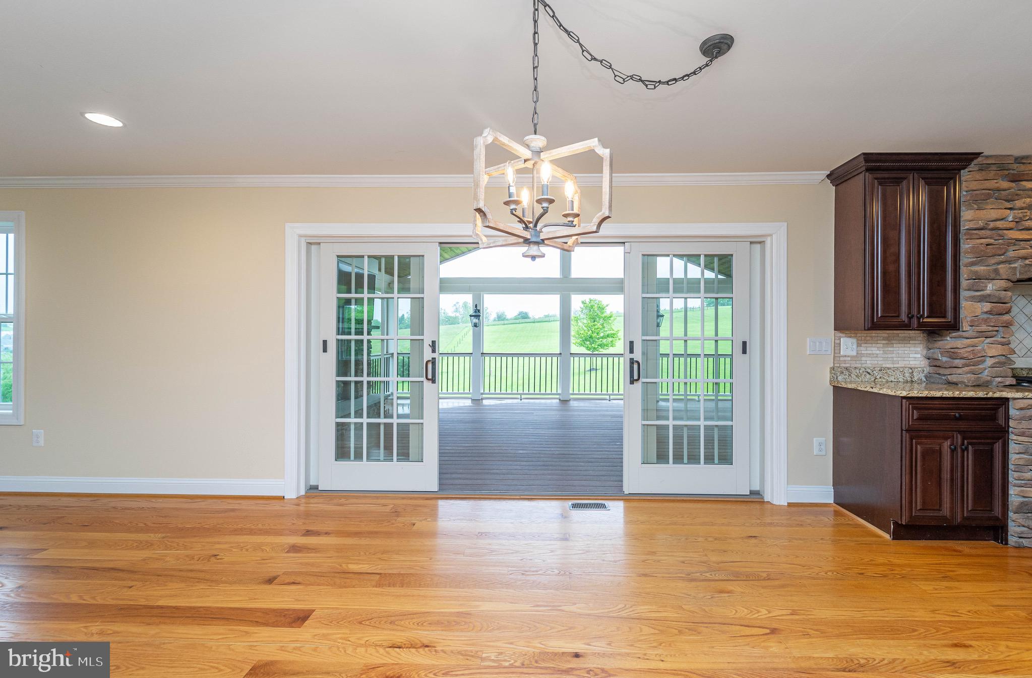 4905 Bartholows Road Mount Airy, MD 21771 - Photo 6 of 70 a view of an empty room with wooden floor and a window
