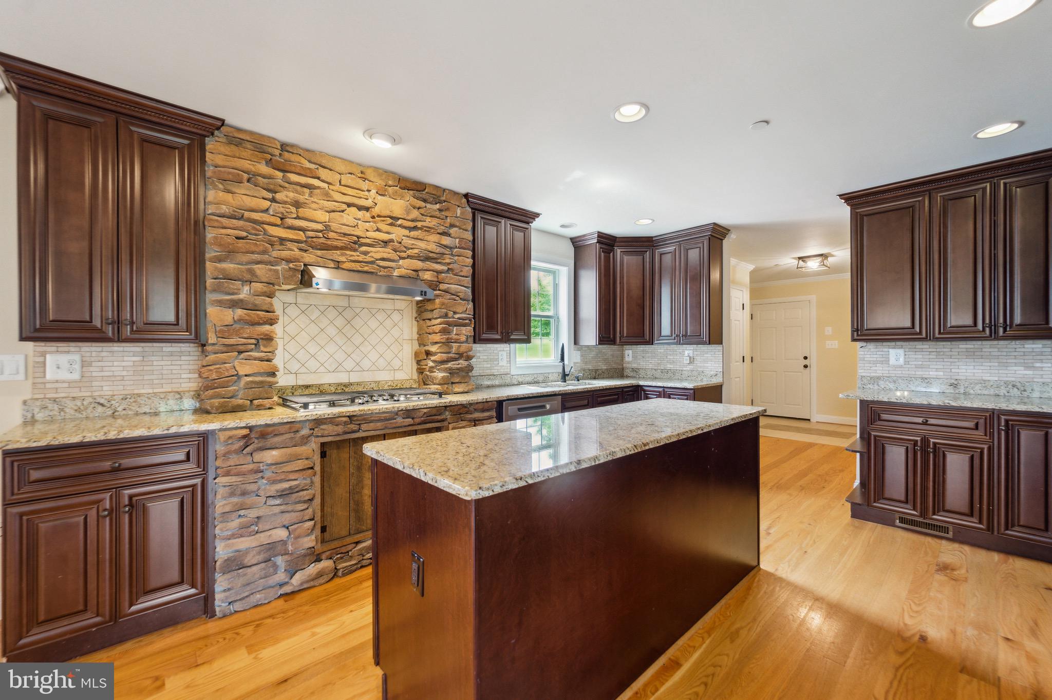4905 Bartholows Road Mount Airy, MD 21771 - Photo 7 of 70 a kitchen with stainless steel appliances granite countertop wooden cabinets sink and stove