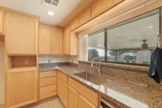 a kitchen with a sink and a refrigerator