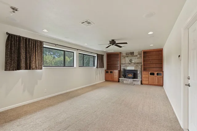 a view of a livingroom with furniture and a ceiling fan