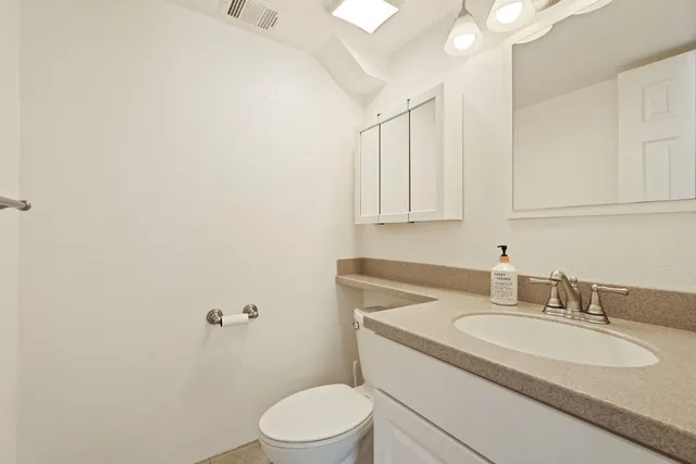 a bathroom with a sink toilet and vanity