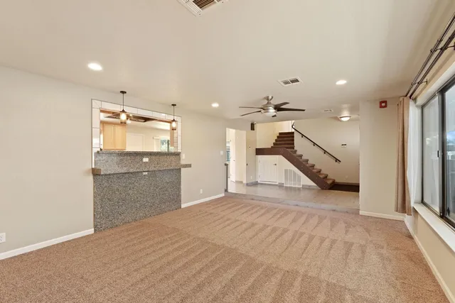 a view of an empty room with a kitchen