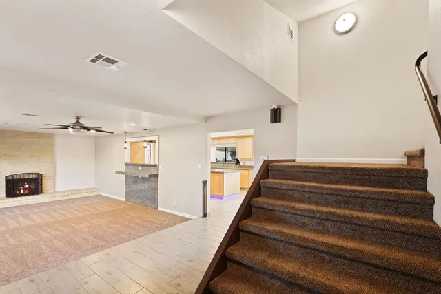 a spacious bedroom with a bed and a chandelier