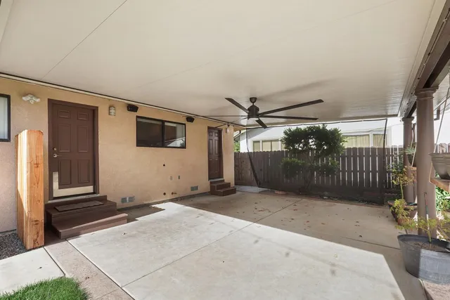 a view of a patio with table and chairs potted plants
