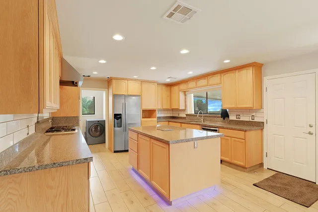 a kitchen with a stove a refrigerator and a sink