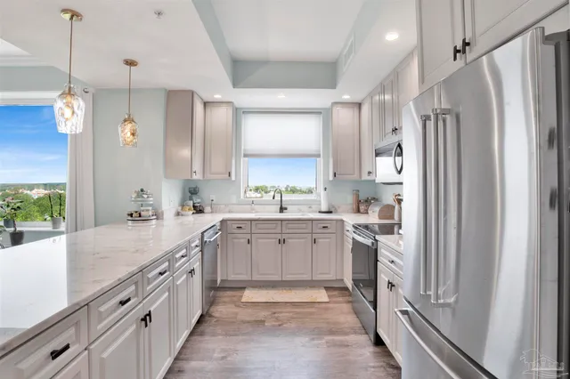 a large kitchen with a sink and refrigerator
