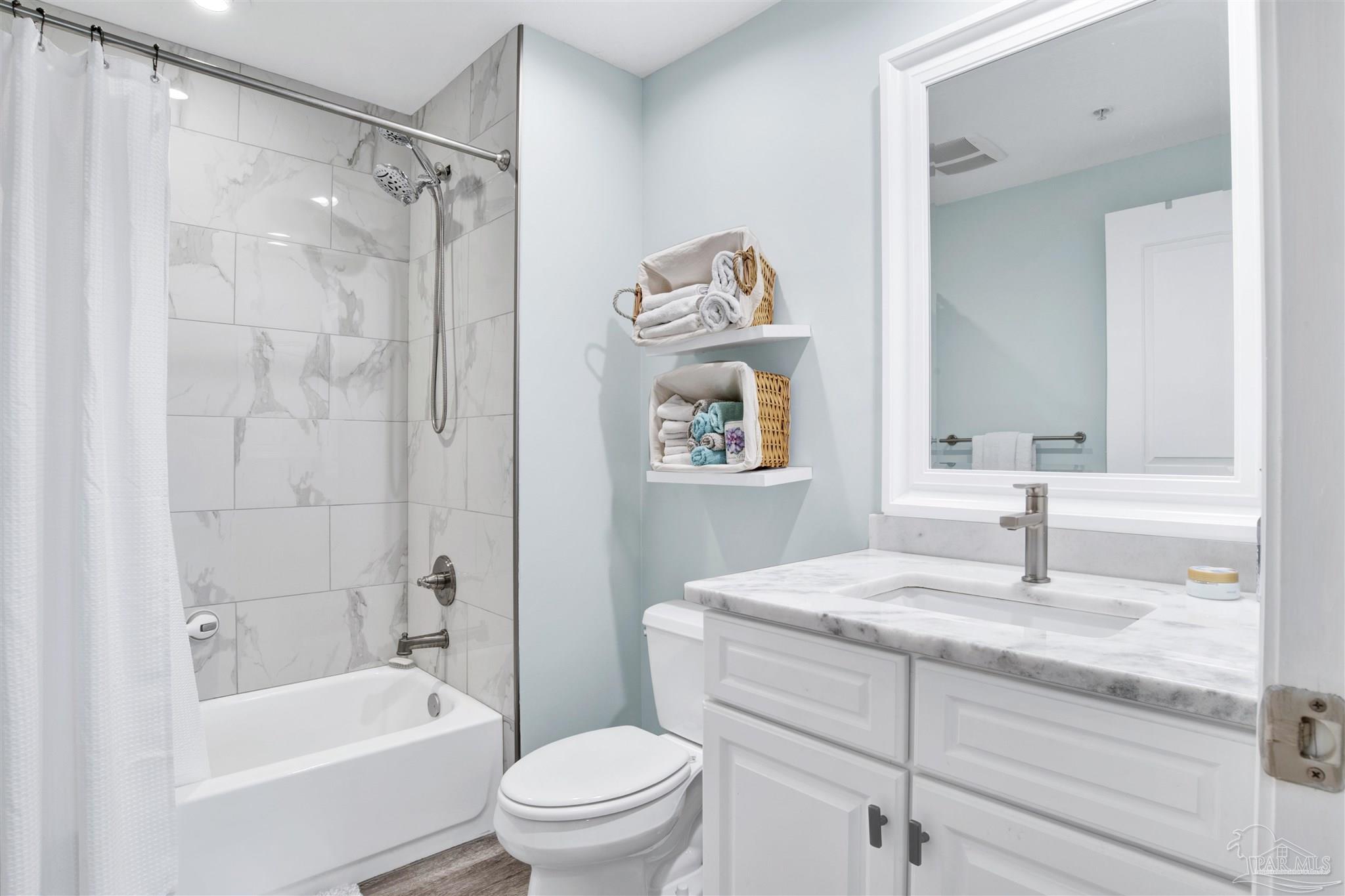 608 Lost Key Drive, Unit 705C Perdido Key, FL 32507 - Photo 11 of 51 a bathroom with a granite countertop sink a toilet and shower
