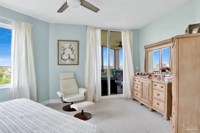 a bedroom with furniture and a large window