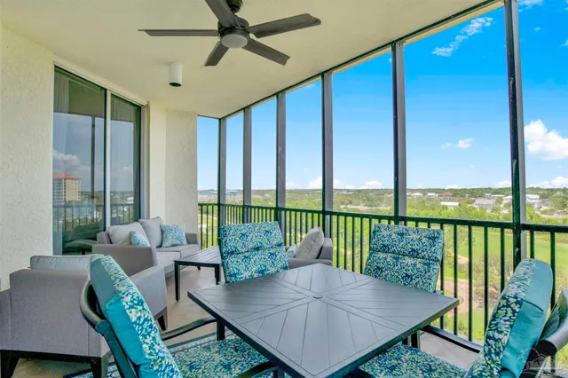 a living room with furniture and a floor to ceiling window