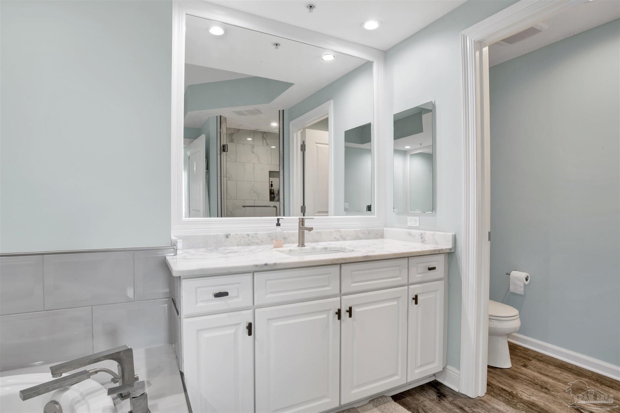 608 Lost Key Drive, Unit 705C Perdido Key, FL 32507 - Photo 22 of 51 a bathroom with a granite countertop sink mirror and toilet