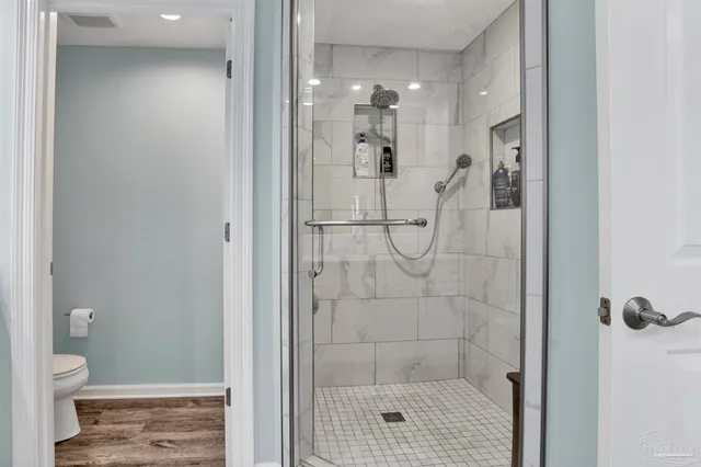 a bathroom with a glass shower door