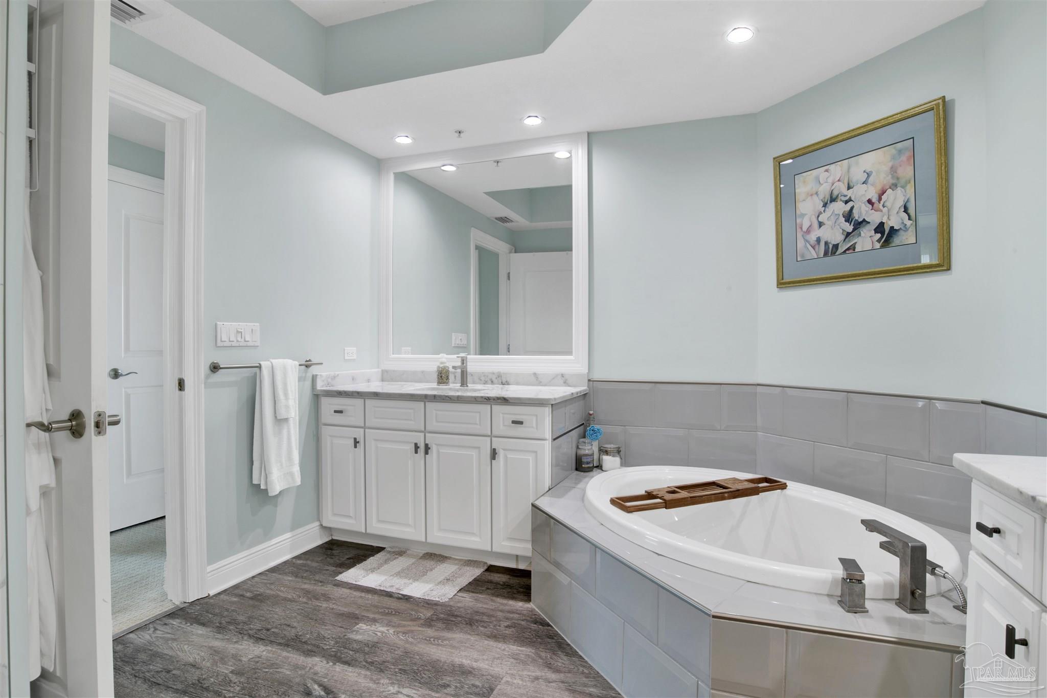608 Lost Key Drive, Unit 705C Perdido Key, FL 32507 - Photo 24 of 51 a bathroom with a tub sink and mirror