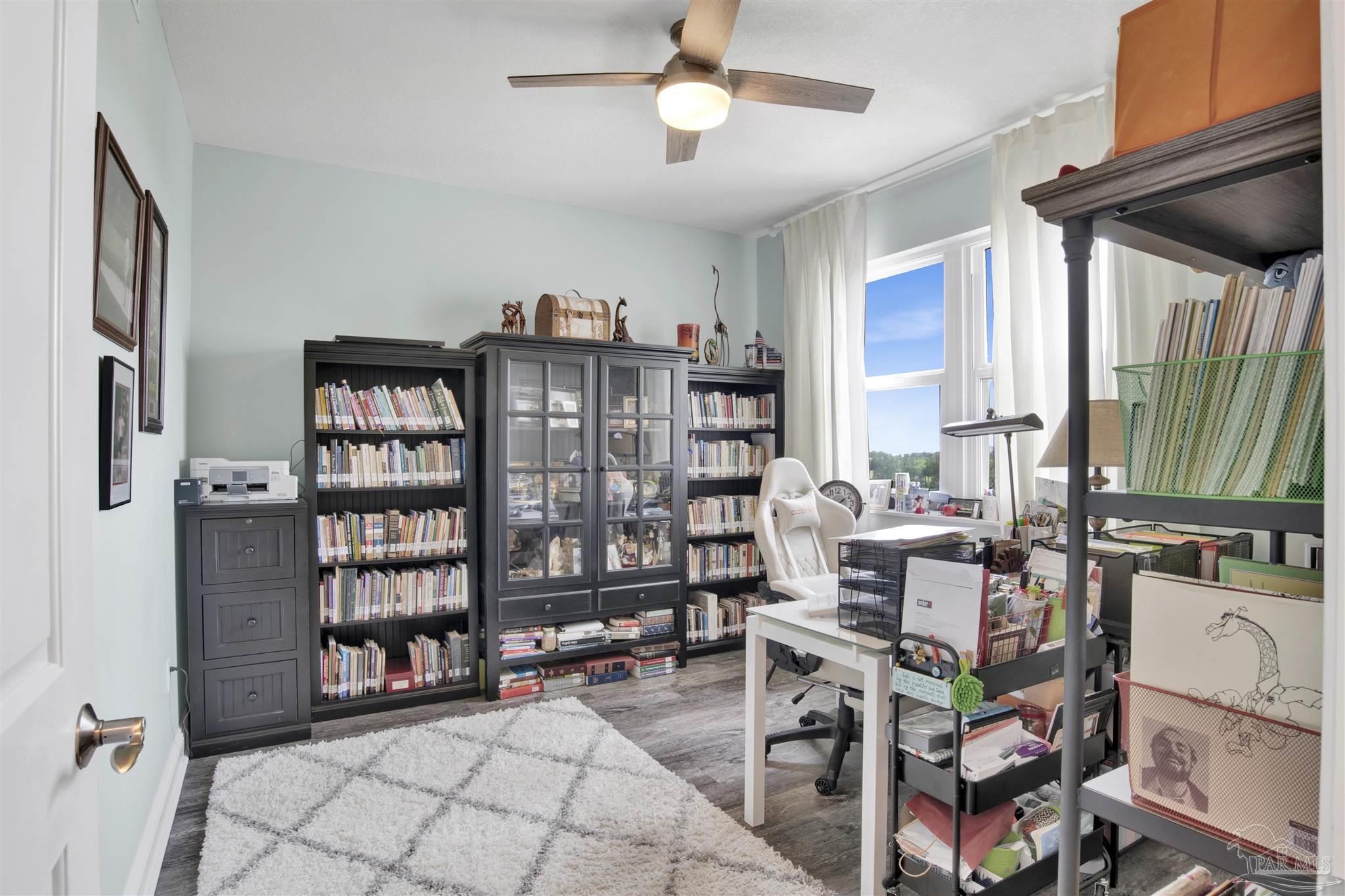 608 Lost Key Drive, Unit 705C Perdido Key, FL 32507 - Photo 25 of 51 a living room with furniture a bookshelf and a window