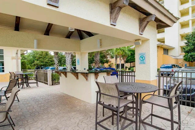 a dining room with furniture and a floor to ceiling window