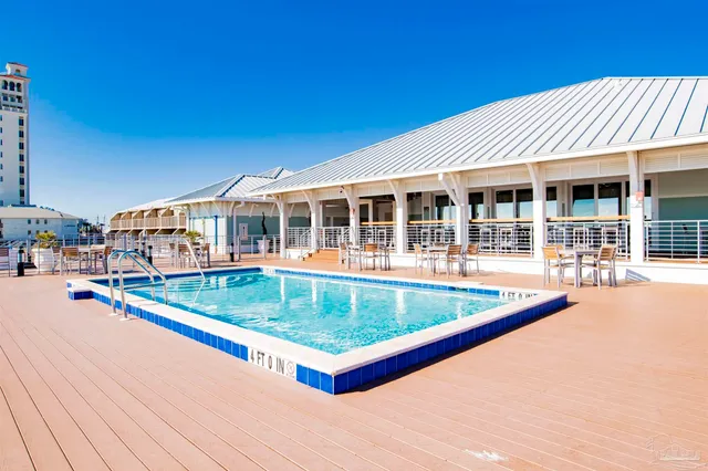 a view of a house with pool and chairs