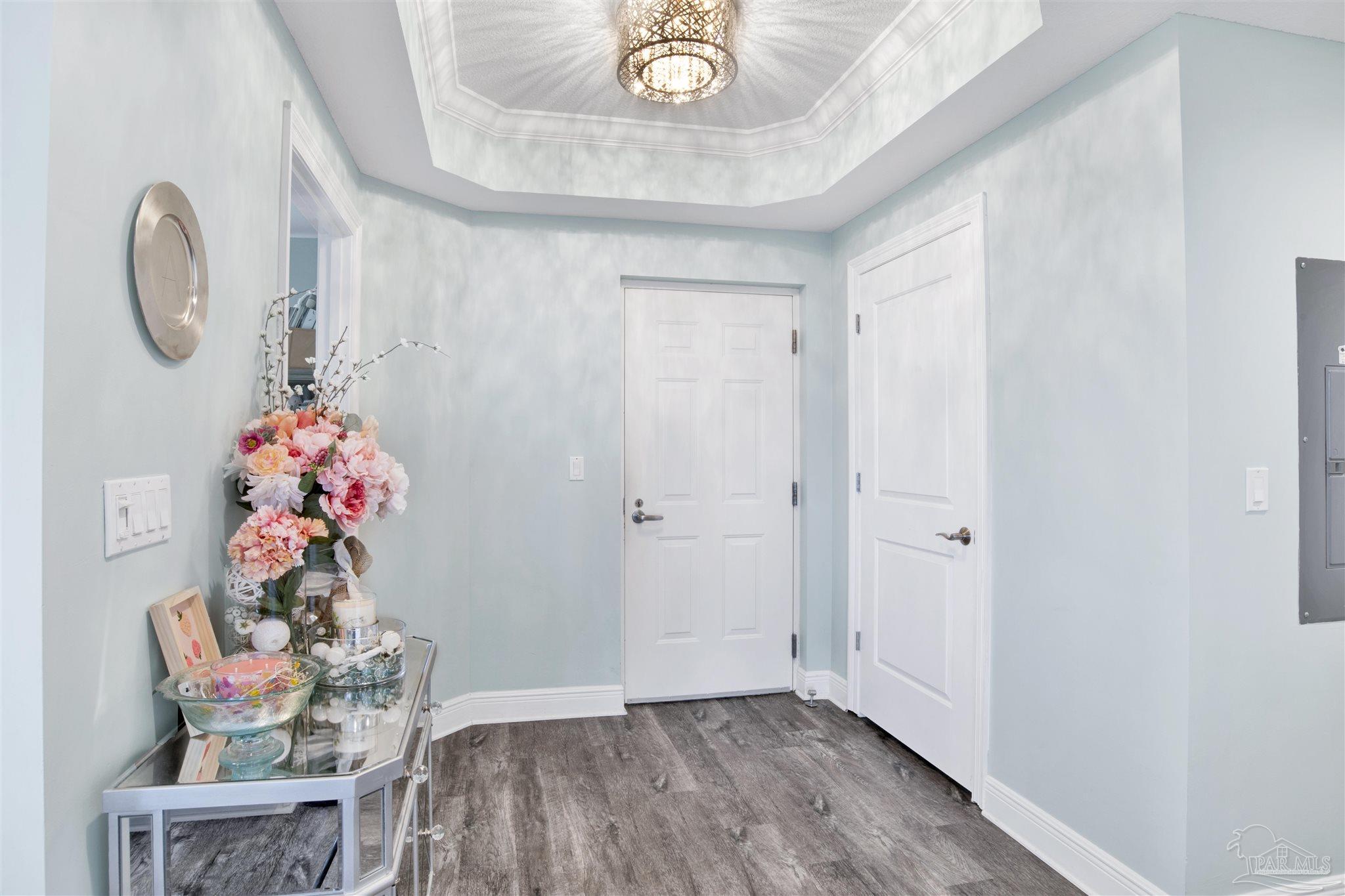 608 Lost Key Drive, Unit 705C Perdido Key, FL 32507 - Photo 8 of 51 a room with wooden floor and a chandelier