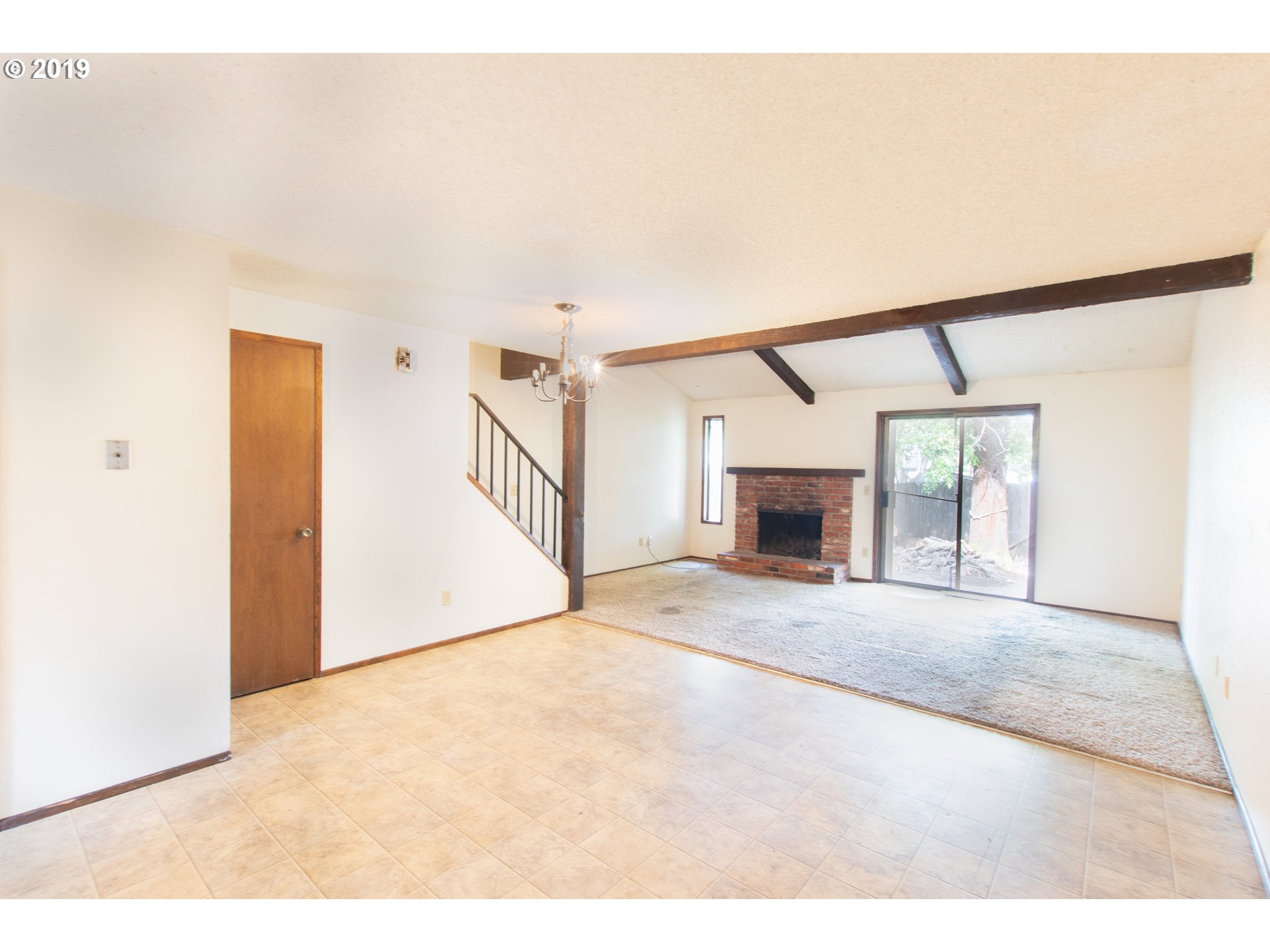 329 South 40th Place Springfield, OR 97478 - Photo 6 of 15 a view of a big room with windows and fireplace