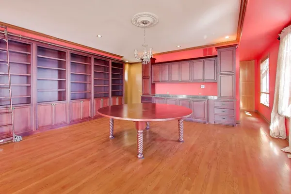 a view of a room with furniture and wooden floor