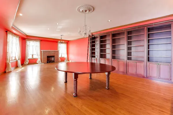 a view of a livingroom with furniture a dinning room and wooden floor