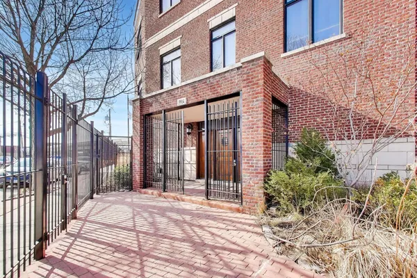 a view of a brick building with many windows