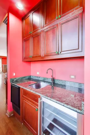 a kitchen with granite countertop stainless steel appliances stove top oven and cabinets