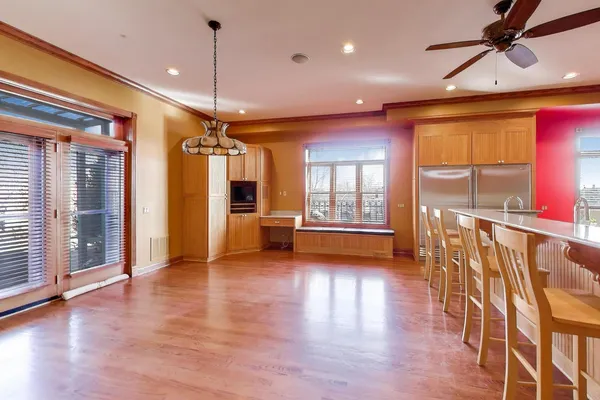 a view of a room with wooden floor stairs and windows