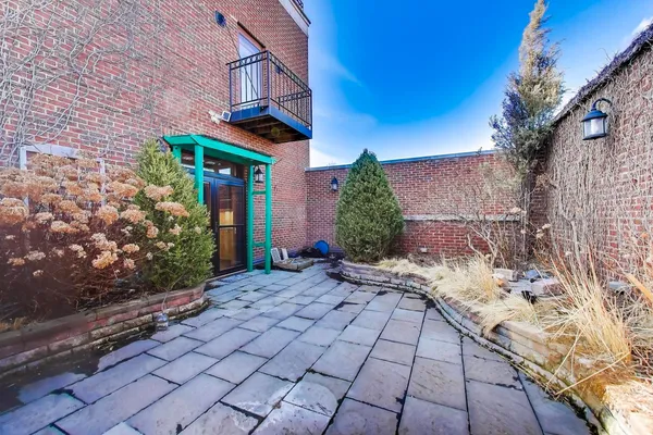 a view of a pathway along with potted plants