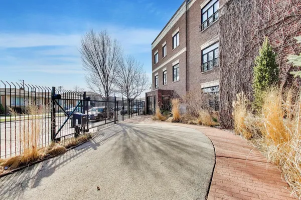 a view of a brick building with a bench in front of it