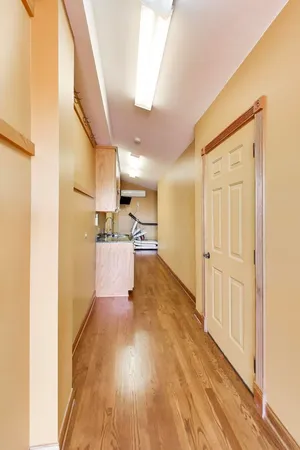 a view of a kitchen with wooden floor