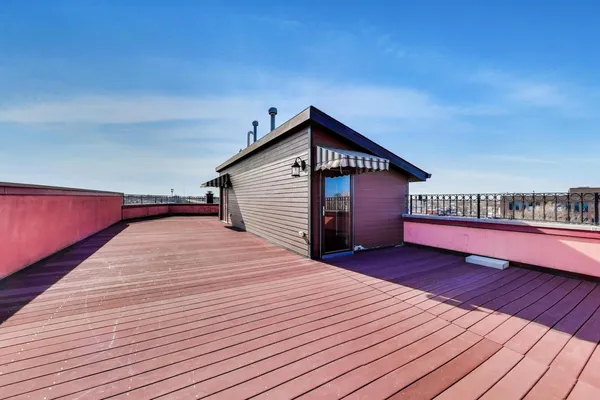 a view of a house with wooden deck