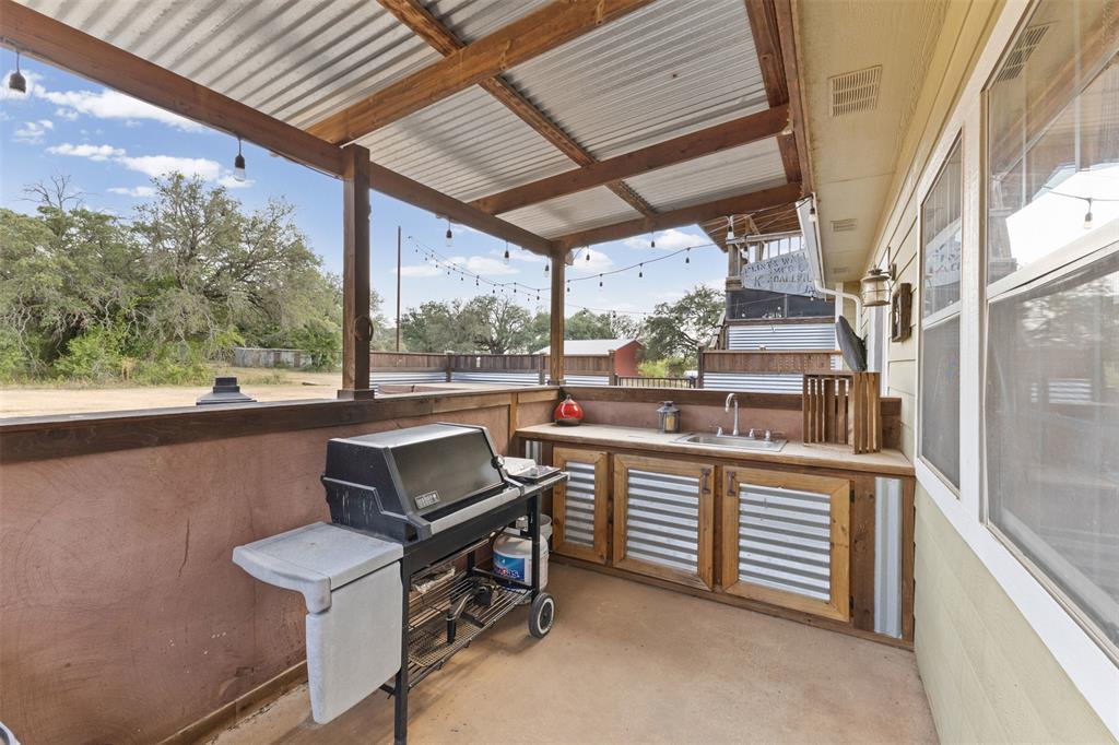 325 Bolton Road Granbury, TX 76049 - Photo 31 of 39 Outdoor kitchen with sink. Grill is negotiable.