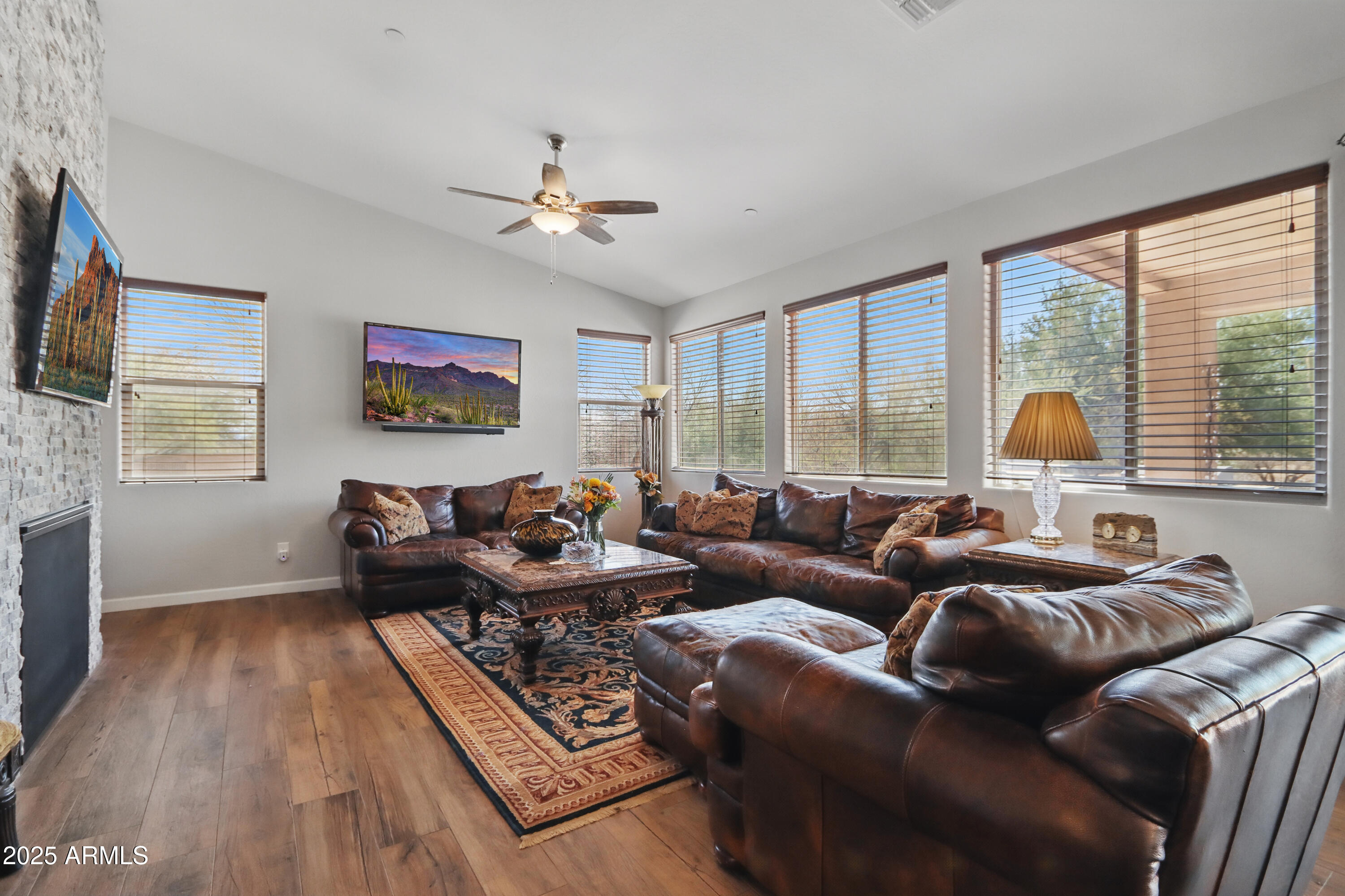 19023 East Buckskin Drive Rio Verde, AZ 85263 - Photo 16 of 58 a living room with furniture a large window and a flat screen tv