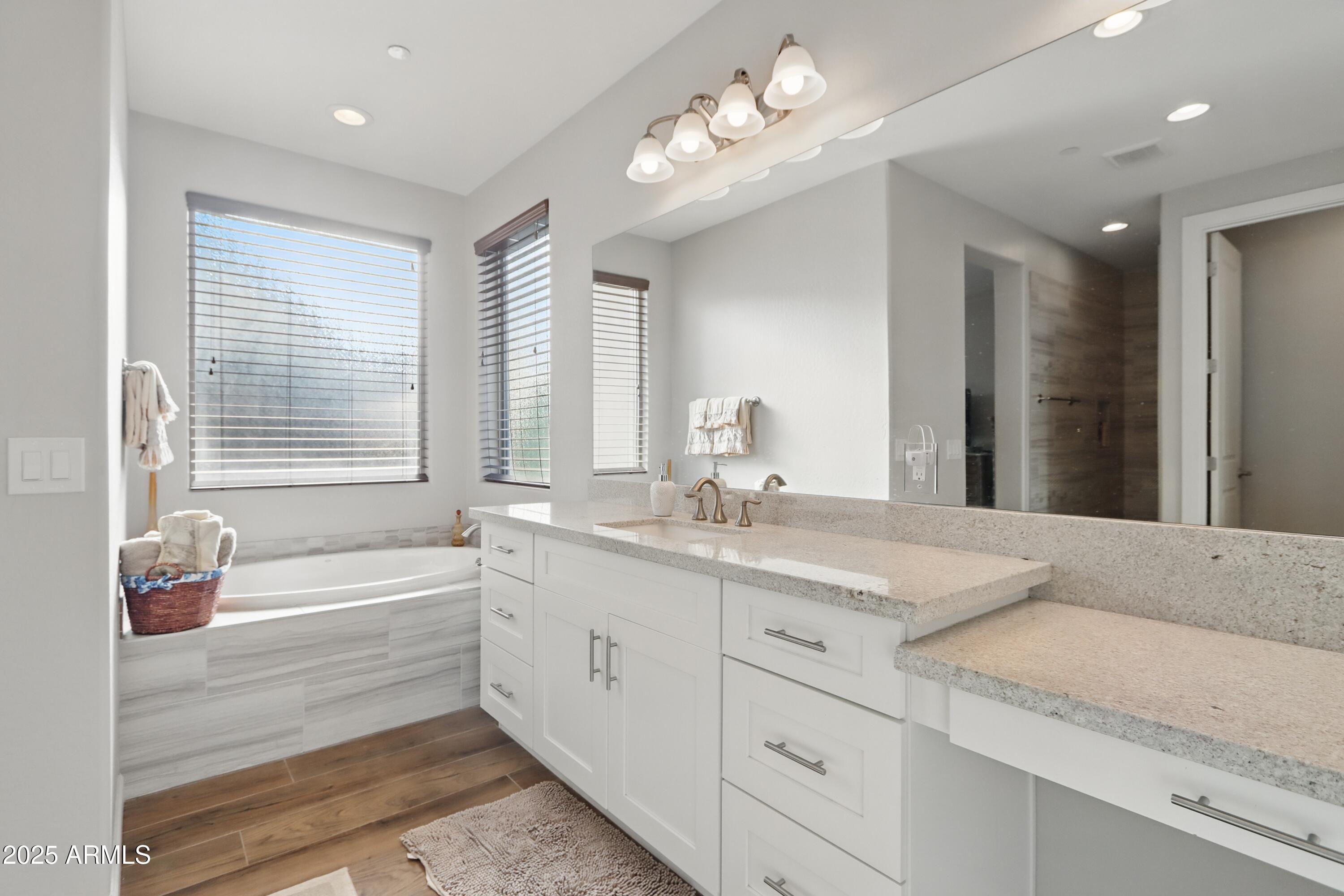 19023 East Buckskin Drive Rio Verde, AZ 85263 - Photo 17 of 31 a spacious bathroom with a granite countertop sink a large mirror and a bathtub